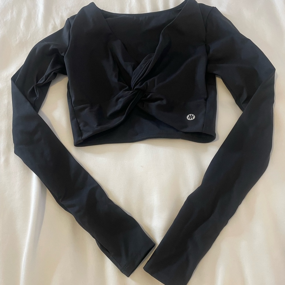 Black stretchy athletic top. Thumb holes. Cropped